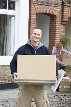 Removal team preparing belongings with safety equipment in Tooting