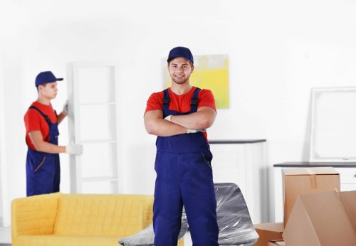 Professional movers handling flat removals in Tooting outside a residential building