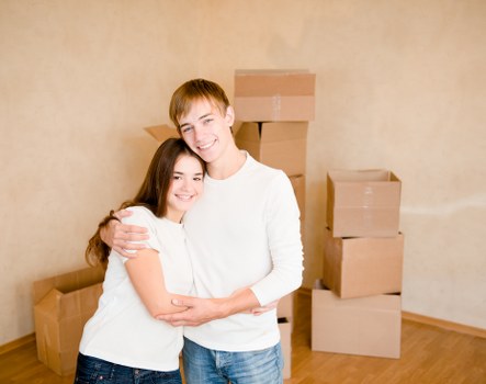 Mover carrying furniture from a Tooting flat staircase