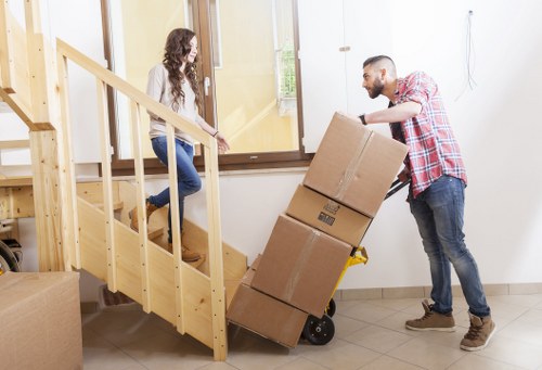 Professional movers handling large household furniture in Tooting