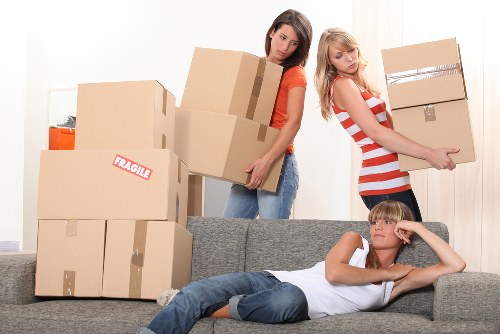 Student moving boxes and furniture in a Tooting flat